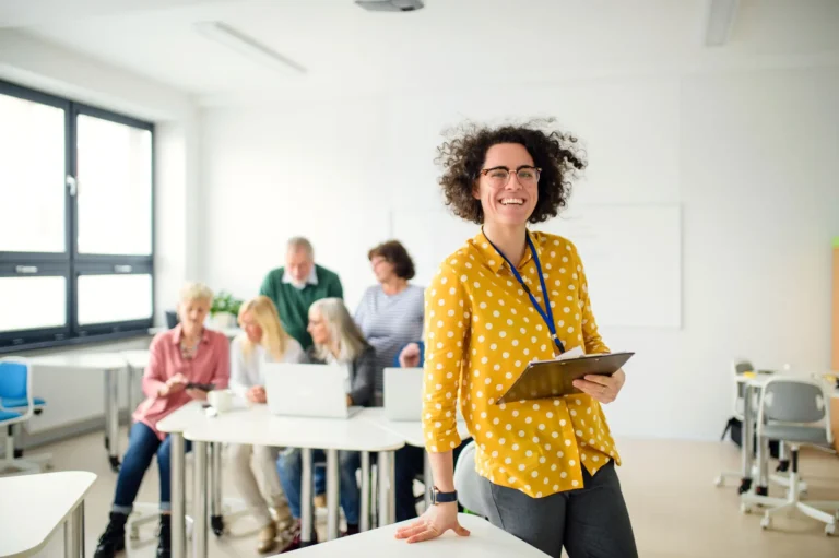 portrait-of-teacher-with-seniors-attending-compute-2023-11-27-04-56-33-utc